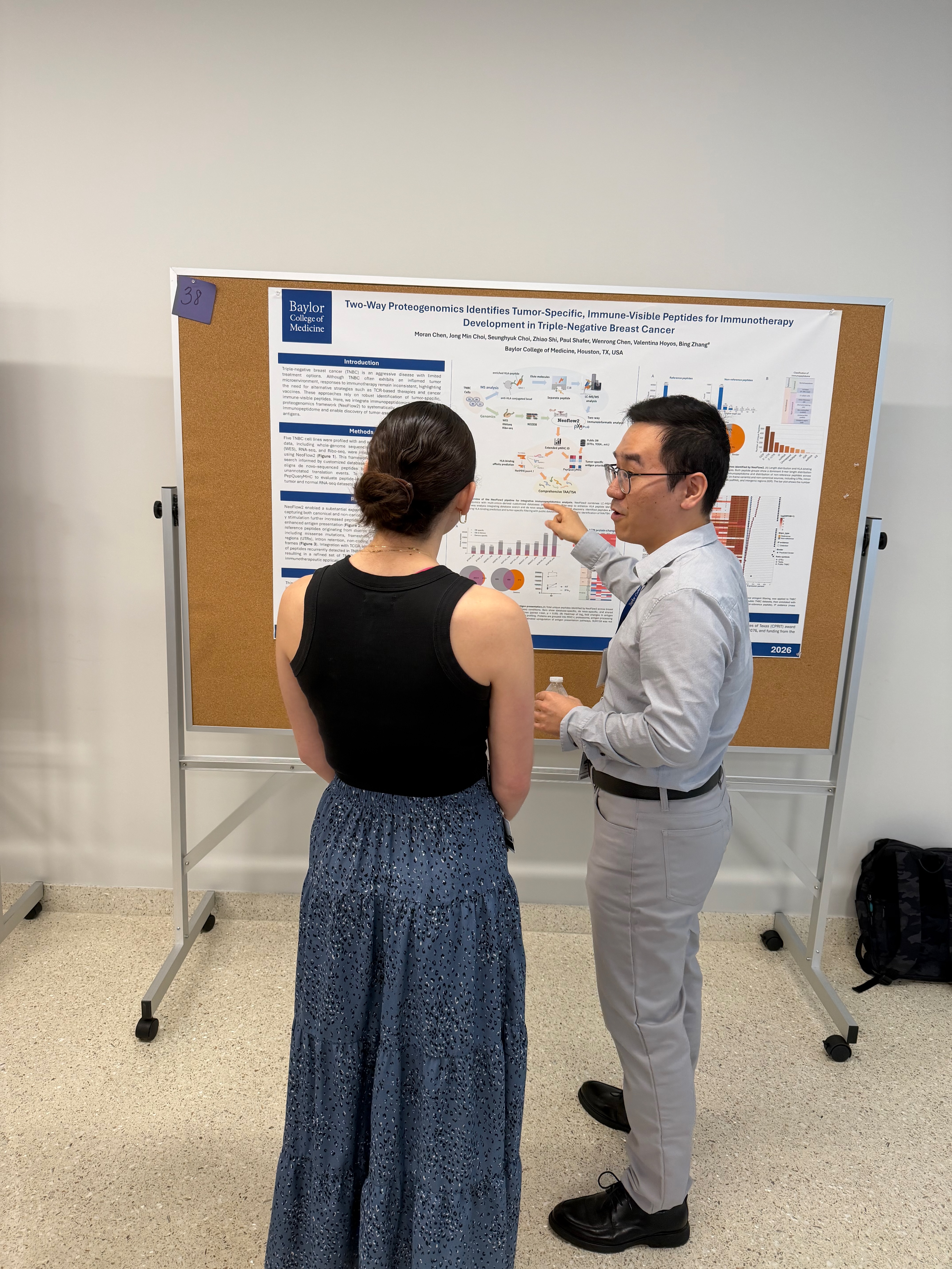 Dr. Moran Chen standing beside his poster at the 13th Annual McNair Symposium